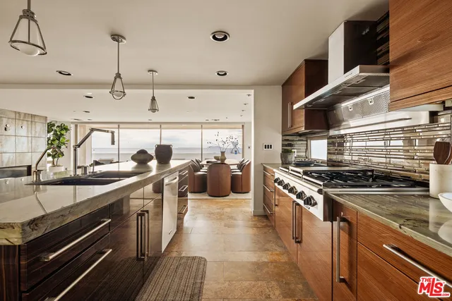 a kitchen with stainless steel appliances a sink stove and cabinets