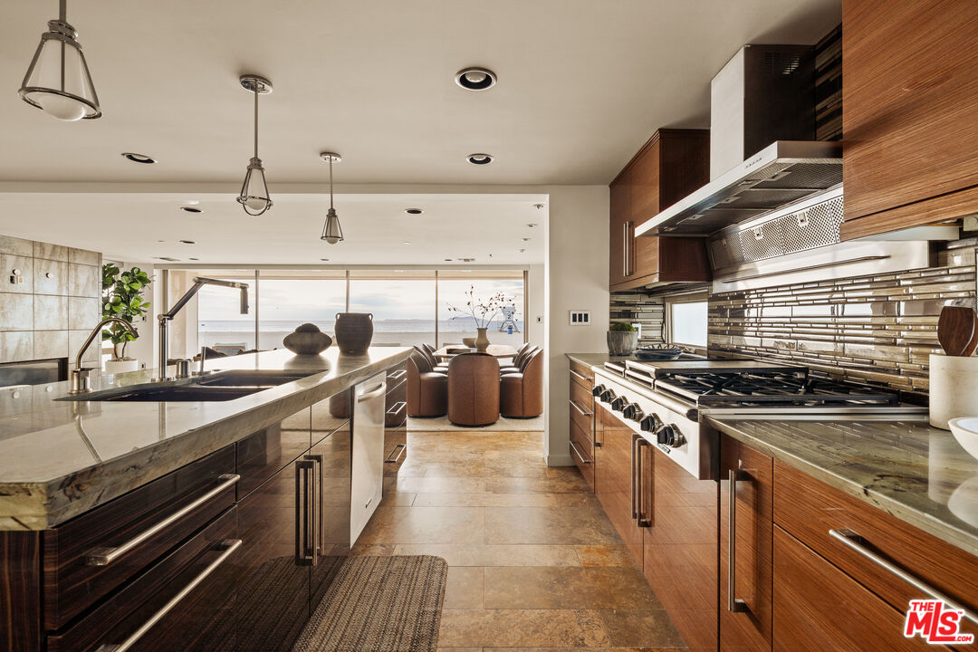 1825 Ocean Drive Oxnard, CA 93035 - Photo 8 of 29 a kitchen with stainless steel appliances a sink stove and cabinets