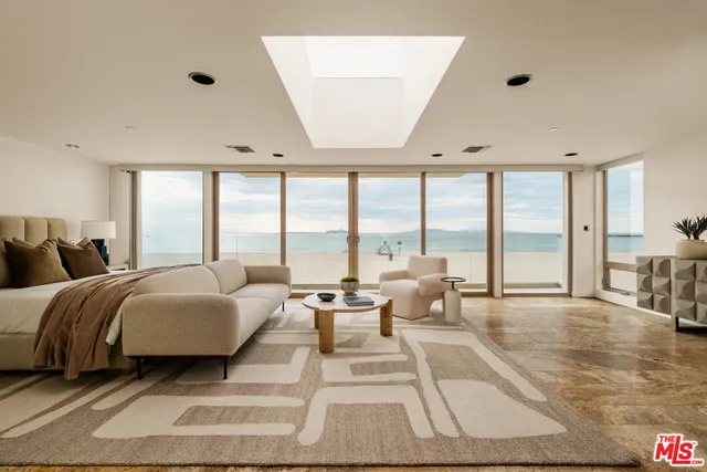 a spacious bedroom with a large bed and large windows