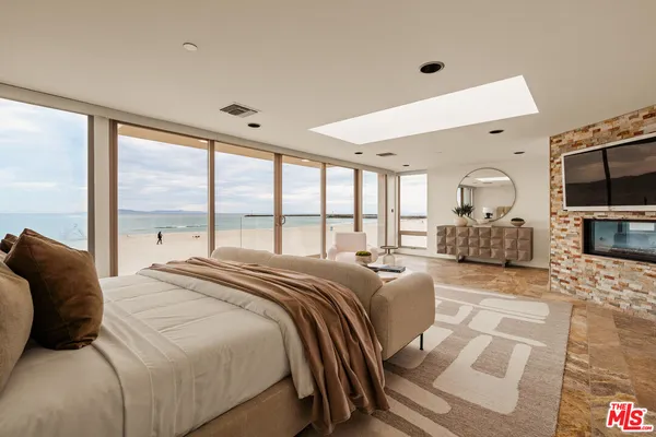 a large bedroom with a large bed and a large window