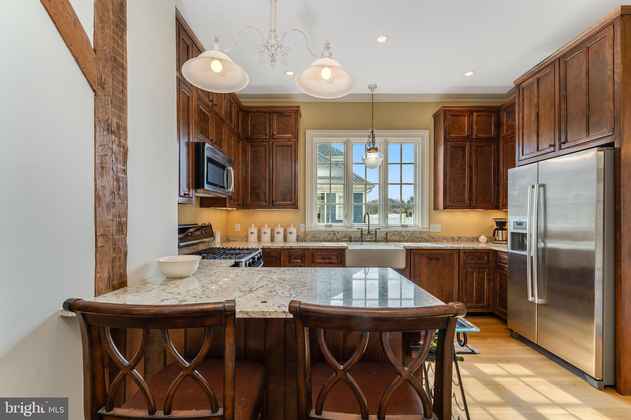 68 West Main Street Clinton, NJ 08809 - Photo 14 of 29 a kitchen with a table chairs refrigerator and microwave