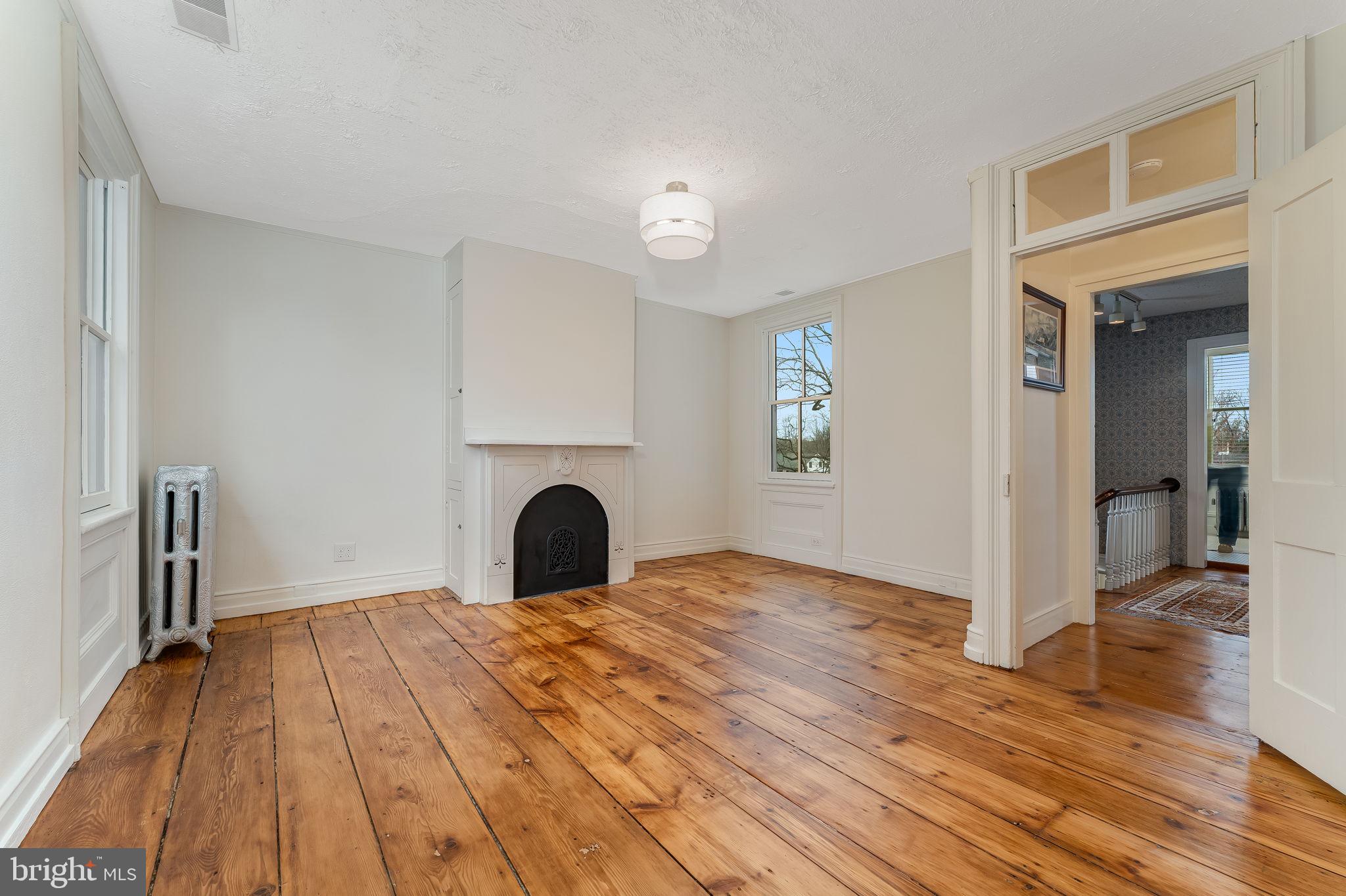 68 West Main Street Clinton, NJ 08809 - Photo 24 of 29 a view of a livingroom with wooden floor and a fireplace