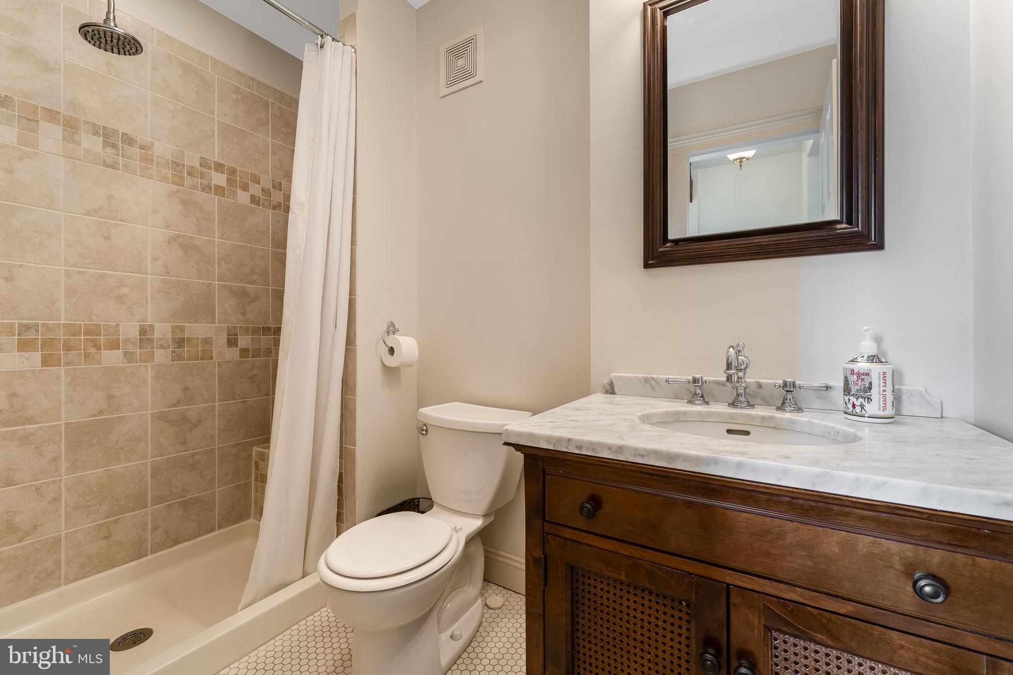 68 West Main Street Clinton, NJ 08809 - Photo 25 of 29 a bathroom with a granite countertop toilet sink and mirror