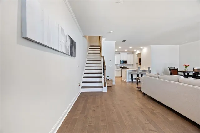 a living room with furniture and stairs