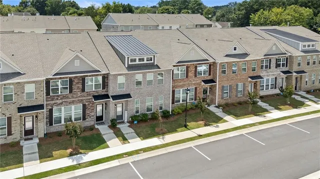 a aerial view of a brick house next to a yard