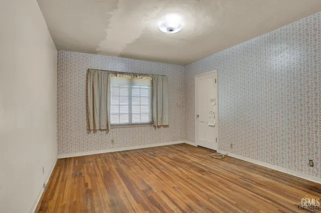 a view of a room with wooden floor