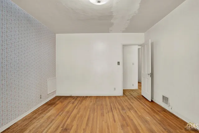 an empty room with wooden floor