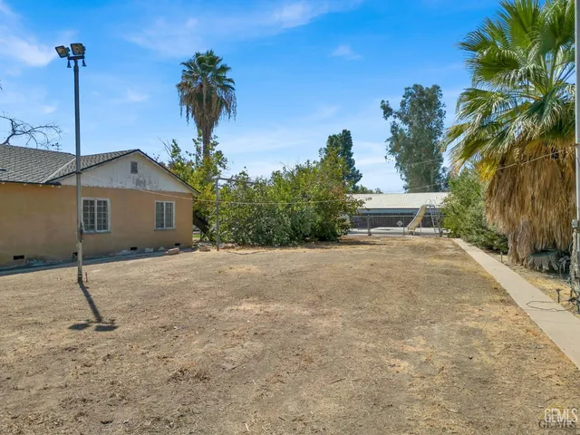 an aerial view of residential houses with outdoor space and ocean view