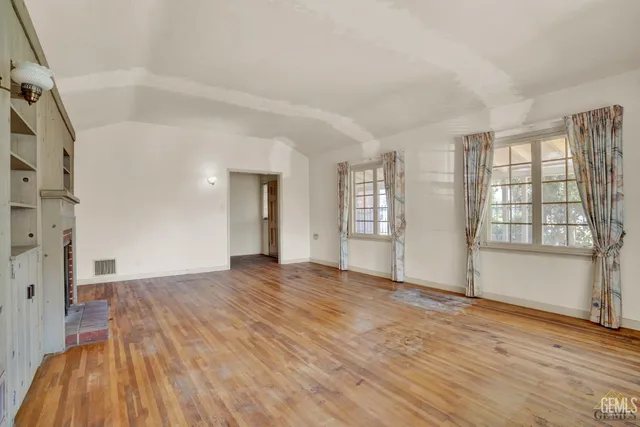 a large kitchen with granite countertop a sink and a stove