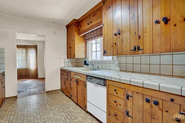 a kitchen with stainless steel appliances granite countertop a refrigerator a oven and white cabinets