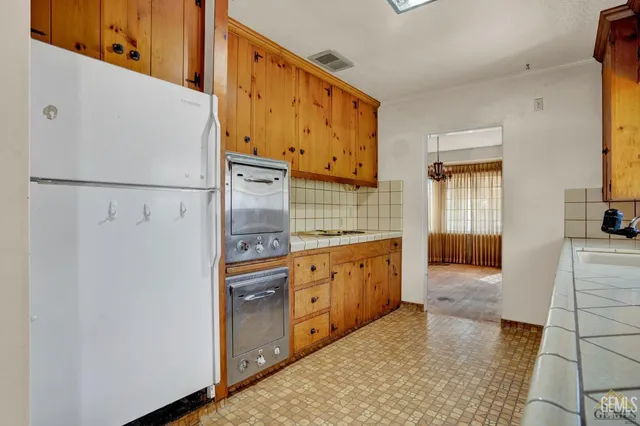 a bathroom with a double vanity sink mirror and shower