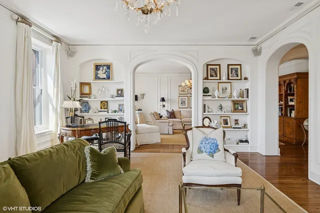 a living room with fireplace furniture and a book shelf