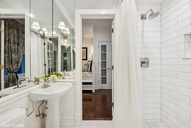 a bathroom with a sink a mirror and shower