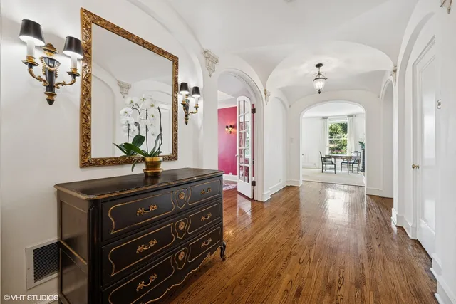 a view of a hallway with wooden floor and stairs