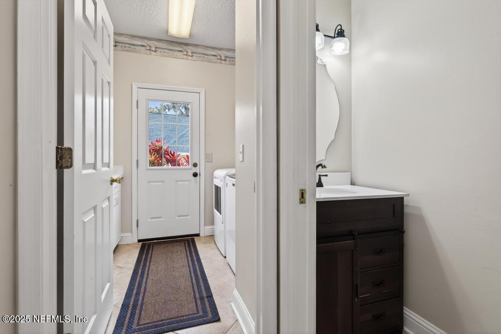 53 Tallwood Road Jacksonville Beach, FL 32250 - Photo 29 of 62 a bathroom with a sink and a mirror