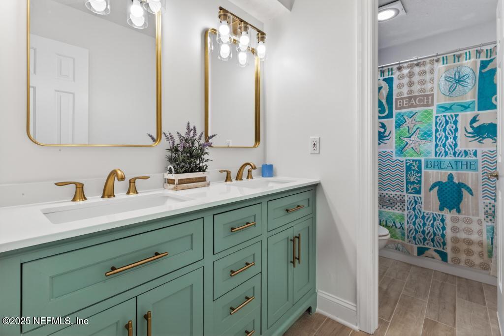 53 Tallwood Road Jacksonville Beach, FL 32250 - Photo 49 of 62 a bathroom with a sink and a mirror