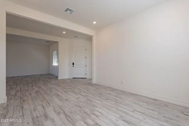 a view of wooden floor and windows in a room