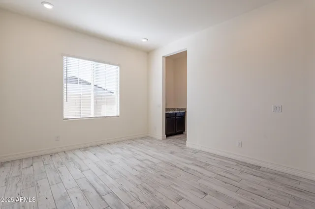 a view of an empty room and wooden floor