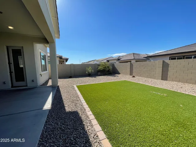 a view of a backyard and swimming pool