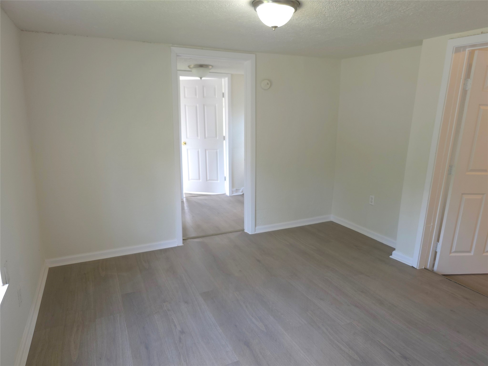 2204 Highway 3 Dickinson, TX 77539 - Photo 12 of 29 a view of an empty room with wooden floor and a window