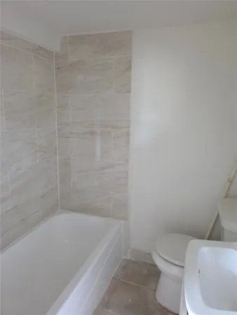a bathroom with a bathtub and toilet