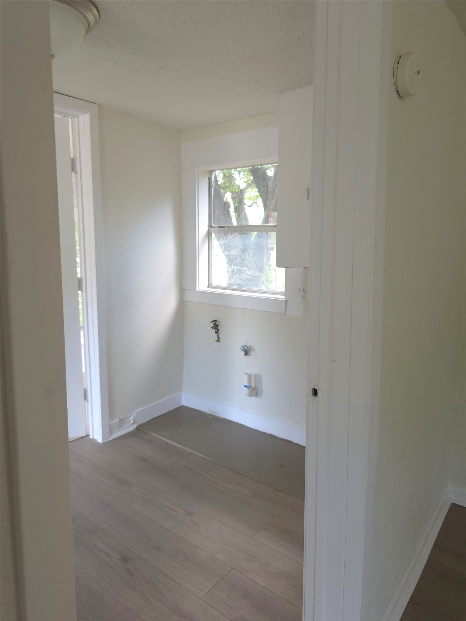 2204 Highway 3 Dickinson, TX 77539 - Photo 19 of 29 an empty room with wooden floor and windows