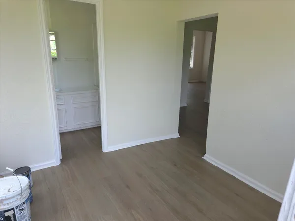 a view of a room with wooden floor and bathroom