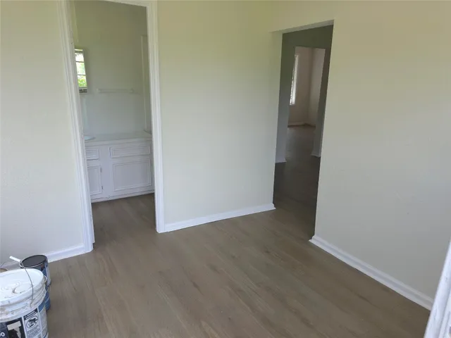 a view of a room with wooden floor and bathroom