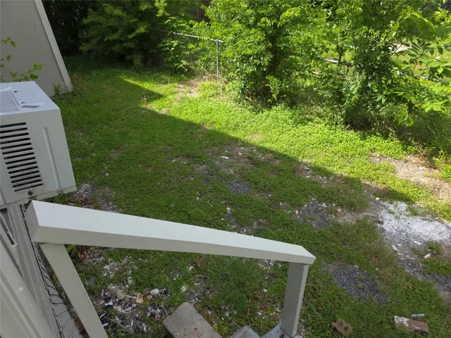 a view of a yard from a balcony