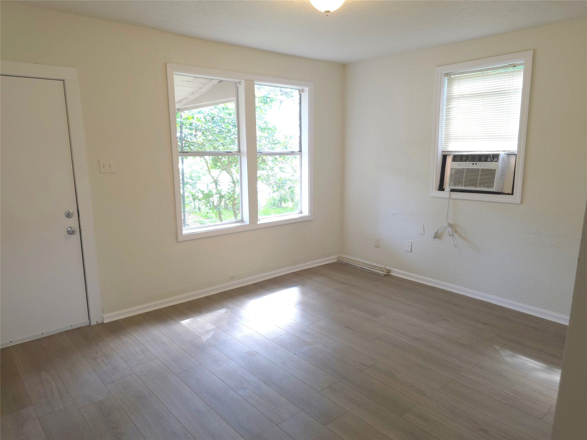 2204 Highway 3 Dickinson, TX 77539 - Photo 5 of 29 an empty room with wooden floor and windows