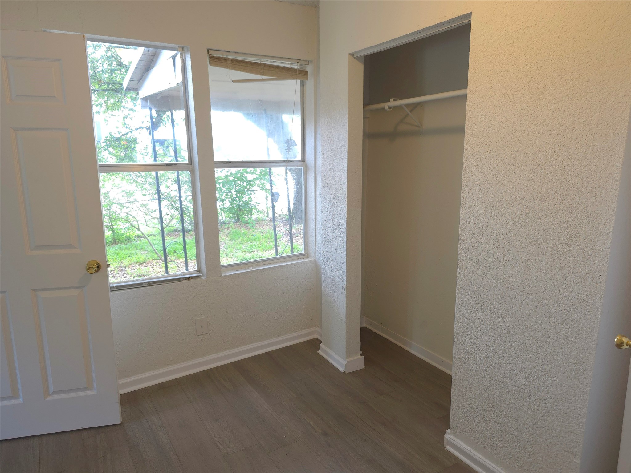 2204 Highway 3 Dickinson, TX 77539 - Photo 7 of 29 an empty room with wooden floor and windows