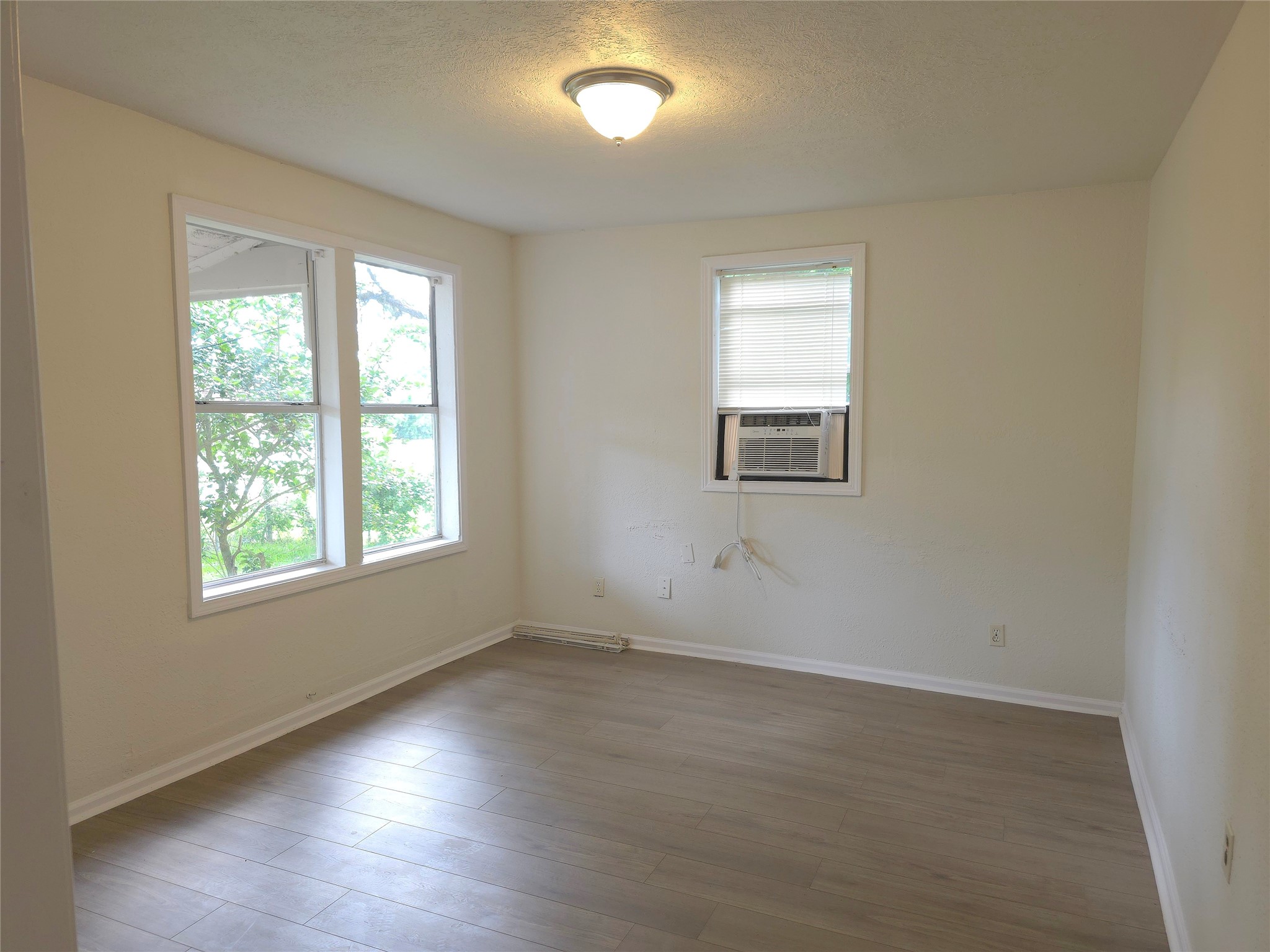 2204 Highway 3 Dickinson, TX 77539 - Photo 8 of 29 an empty room with wooden floor and windows