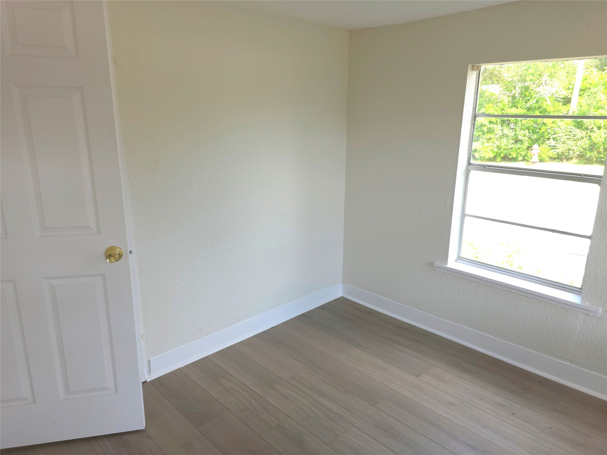 2204 Highway 3 Dickinson, TX 77539 - Photo 9 of 29 an empty room with wooden floor and windows