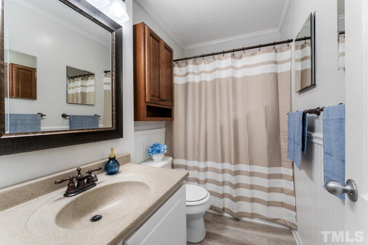 1955 Bernard Street Raleigh, NC 27608 - Photo 12 of 42 a bathroom with a sink toilet and shower