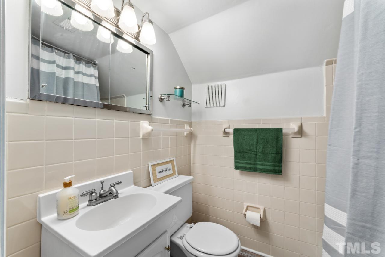 1955 Bernard Street Raleigh, NC 27608 - Photo 23 of 42 a bathroom with a sink mirror and toilet