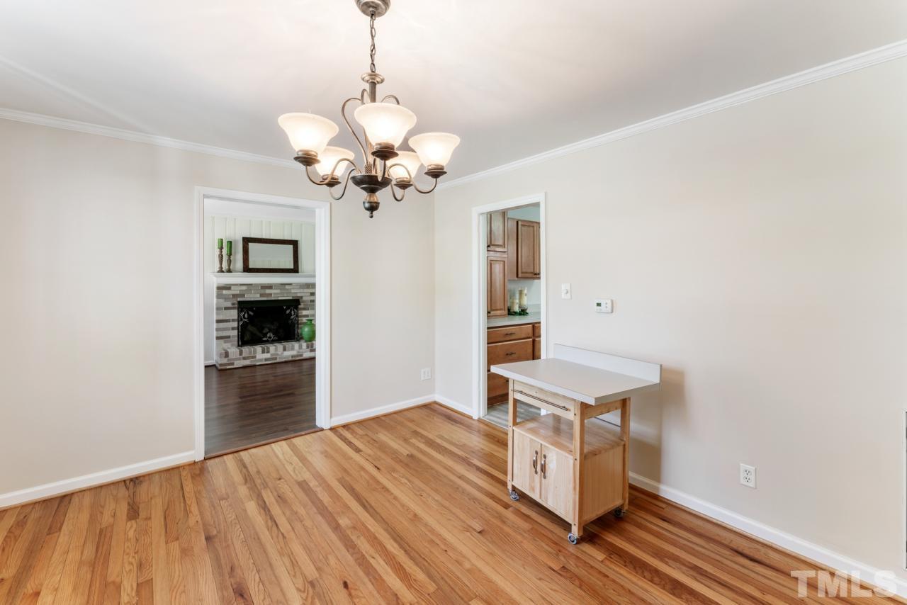 1955 Bernard Street Raleigh, NC 27608 - Photo 3 of 42 a room with chandelier and wooden floor