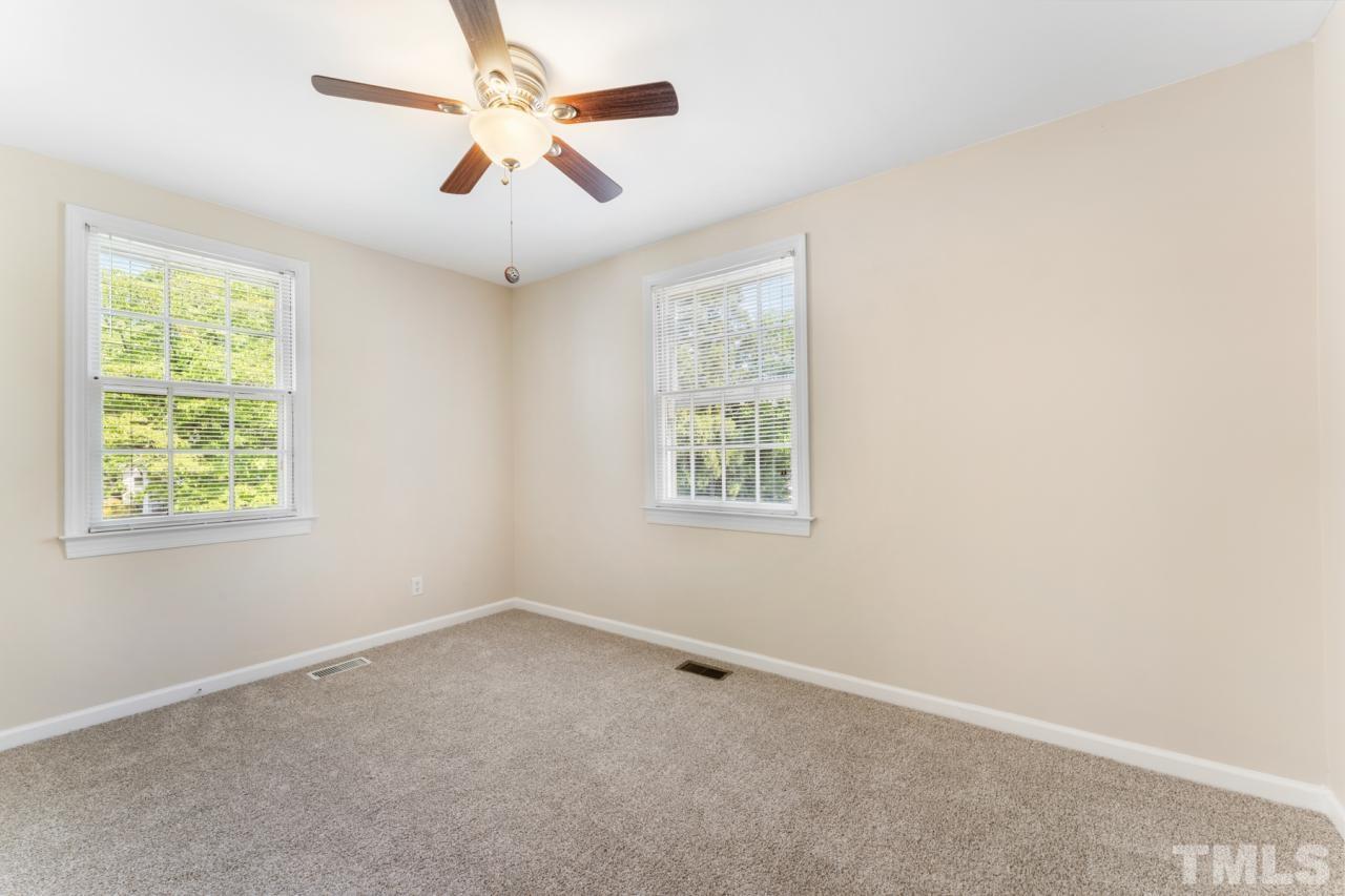 1955 Bernard Street Raleigh, NC 27608 - Photo 10 of 42 an empty room with a window and a fan
