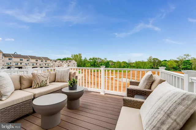 a patio with couches and a potted plant