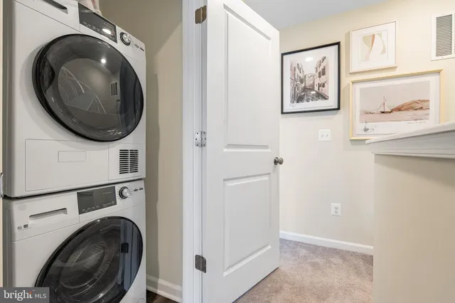 a view of a hallway with washer and dryer