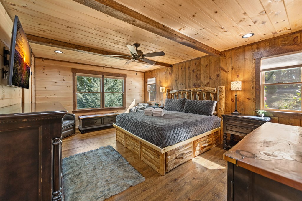 588 Bell Camp Ridge Road Blue Ridge, GA 30513 - Photo 16 of 29 a bedroom with a bed and wooden floor