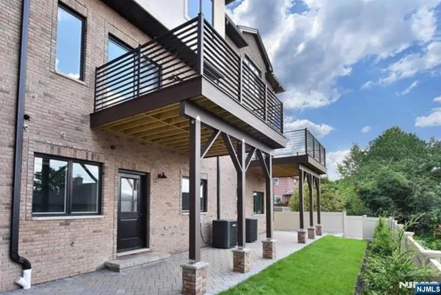a view of a house with brick walls