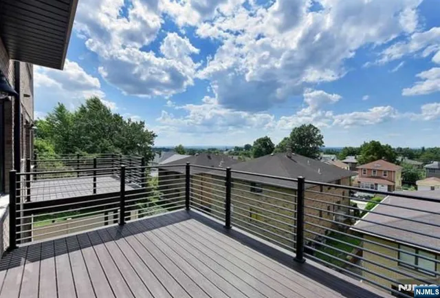 a view of a balcony with wooden floor and city view