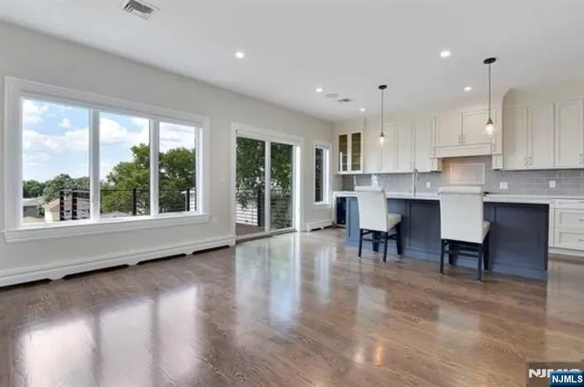 a view of kitchen with furniture and wooden floor