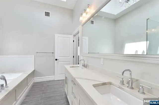 a bathroom with a sink and a large mirror