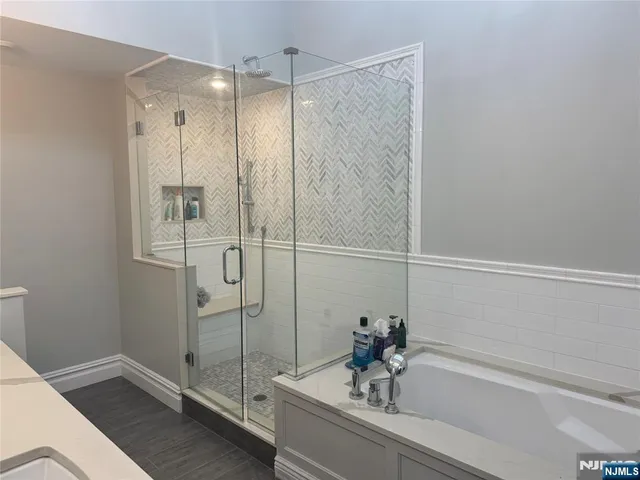 a bathroom with a bathtub and a shower