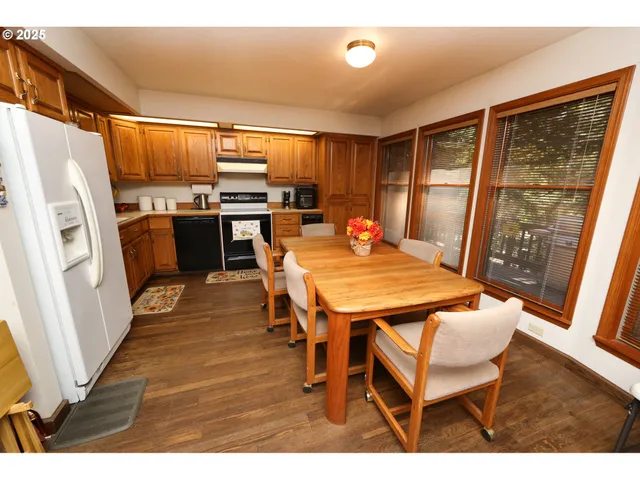 a kitchen with stainless steel appliances kitchen island granite countertop a refrigerator a stove and a sink
