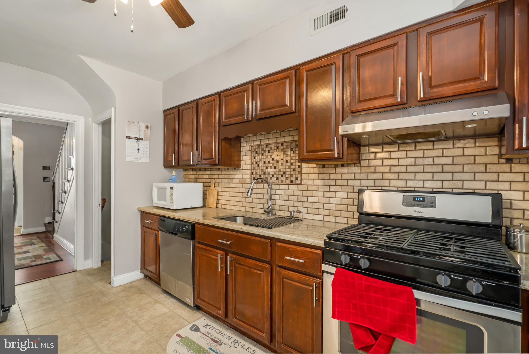 3704 Monterey Road Baltimore, MD 21218 - Photo 11 of 32 a kitchen with granite countertop stainless steel appliances and sink