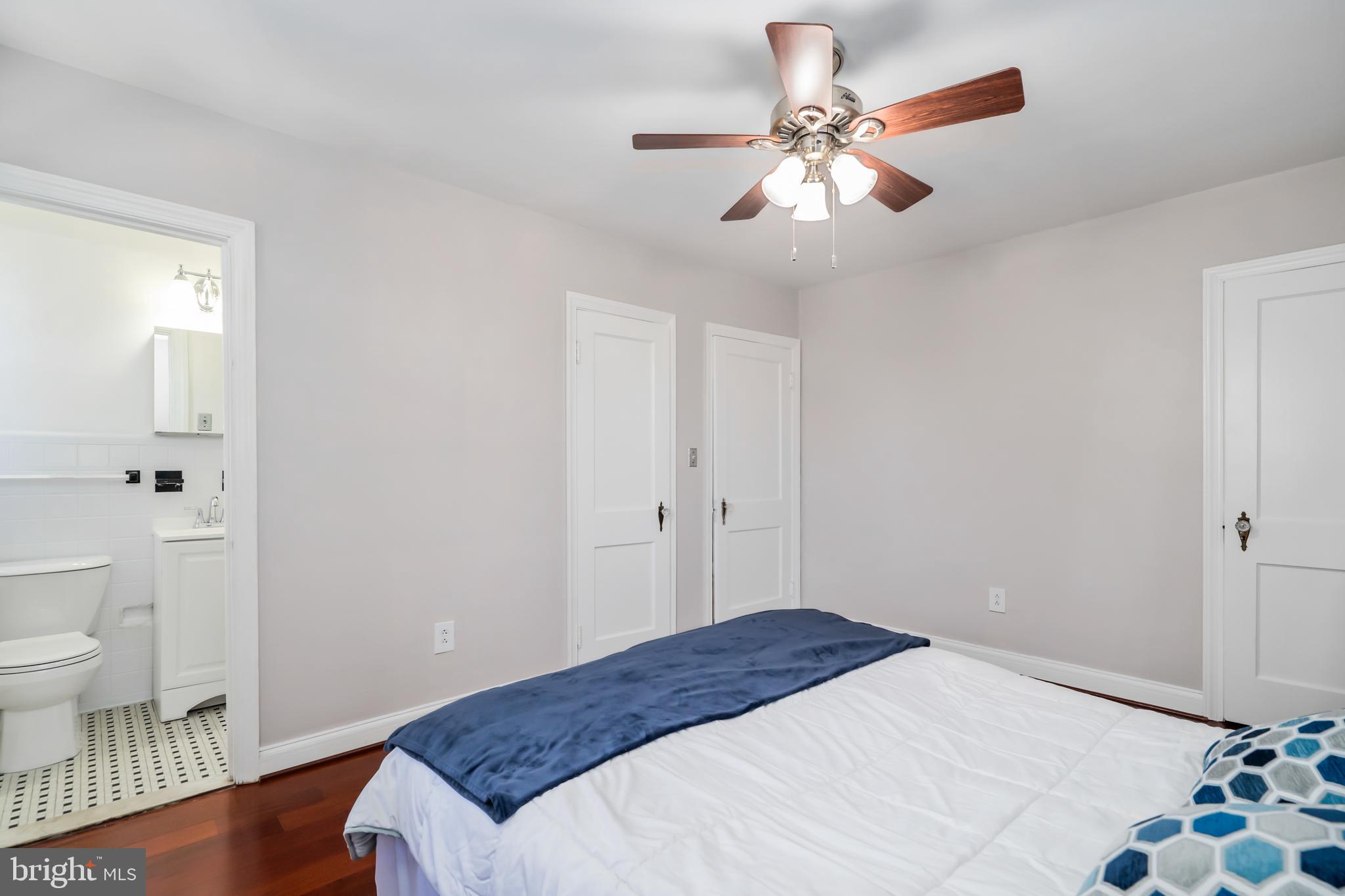3704 Monterey Road Baltimore, MD 21218 - Photo 14 of 32 a bedroom with a bed and a chandelier