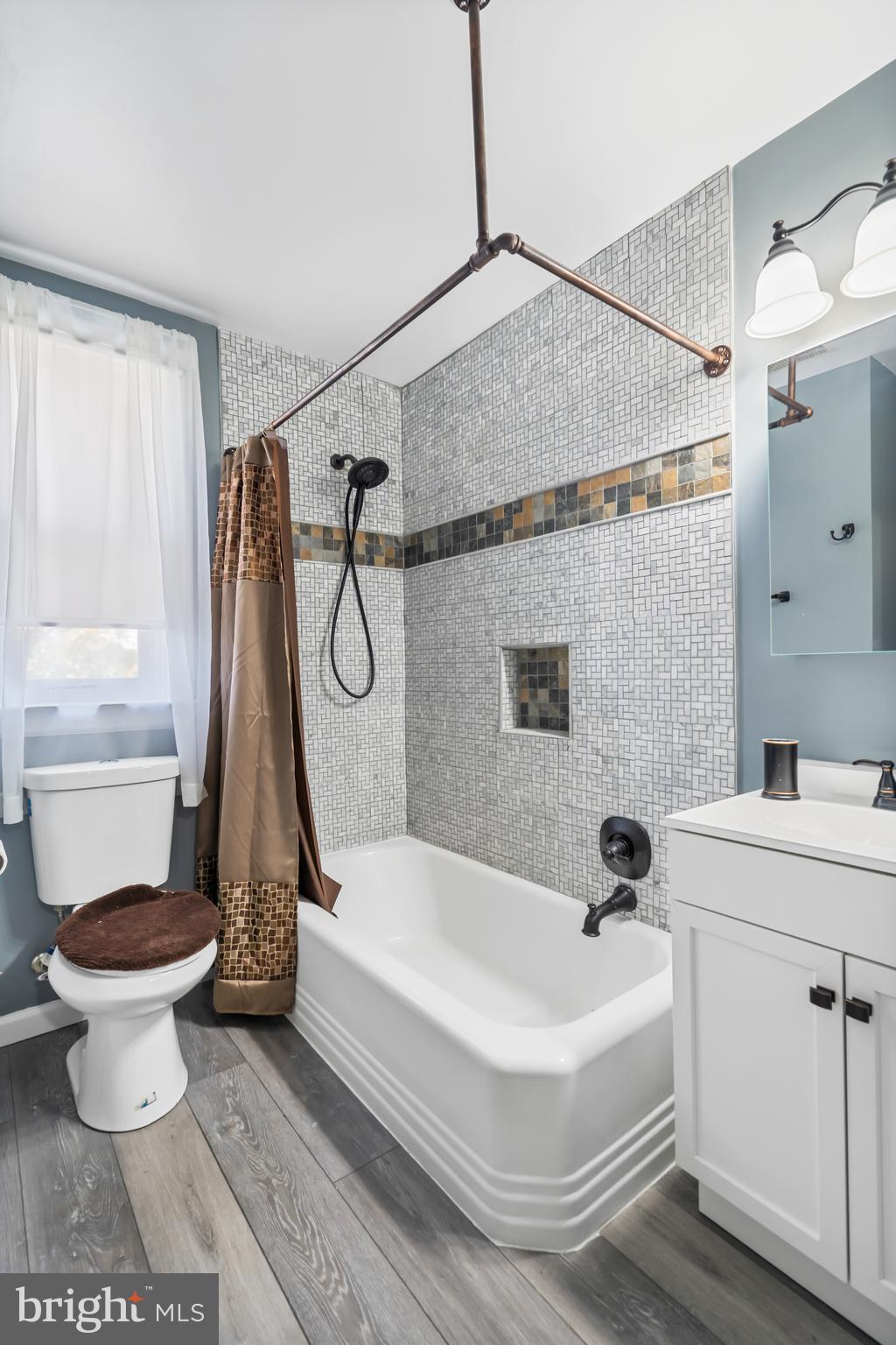 3704 Monterey Road Baltimore, MD 21218 - Photo 21 of 32 a bathroom with a white bath tub a toilet and a sink
