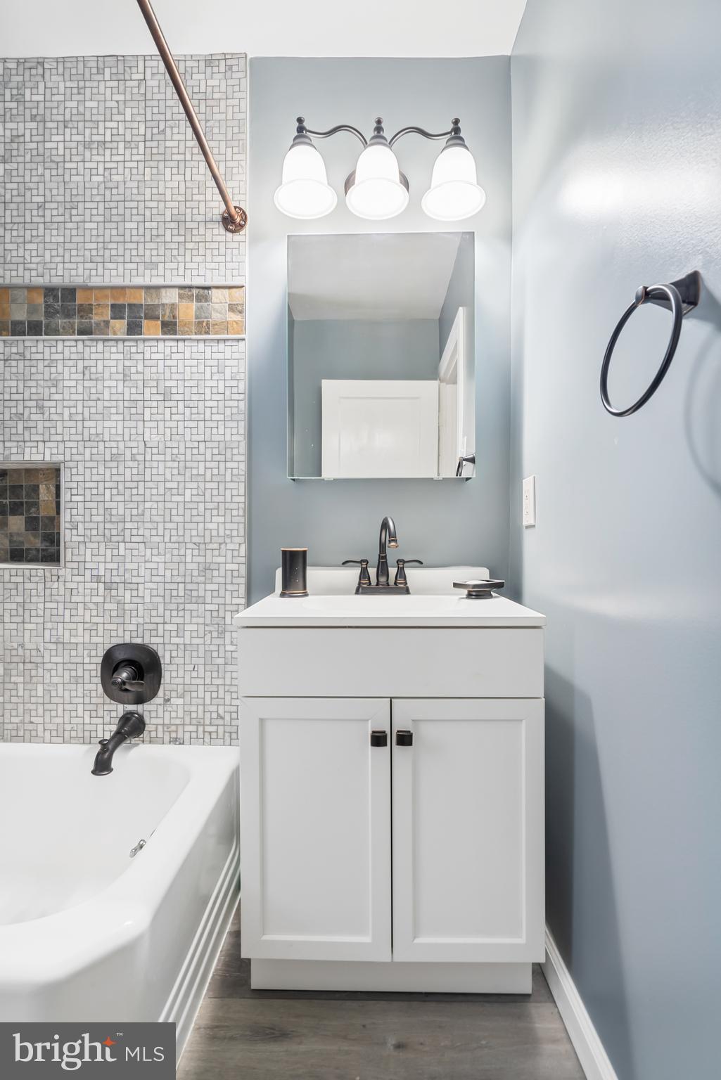3704 Monterey Road Baltimore, MD 21218 - Photo 23 of 32 a bathroom with a sink and a mirror